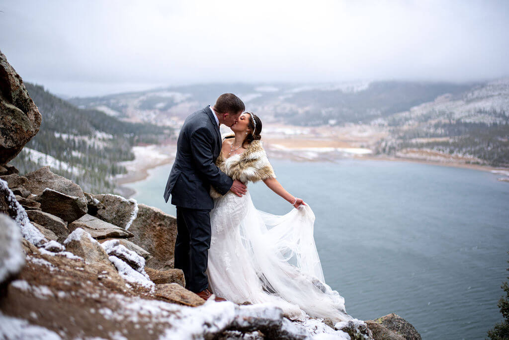Bride and groom share a kiss overlooking the Dillion reservoir as they explore the area around Sapphire Point. 