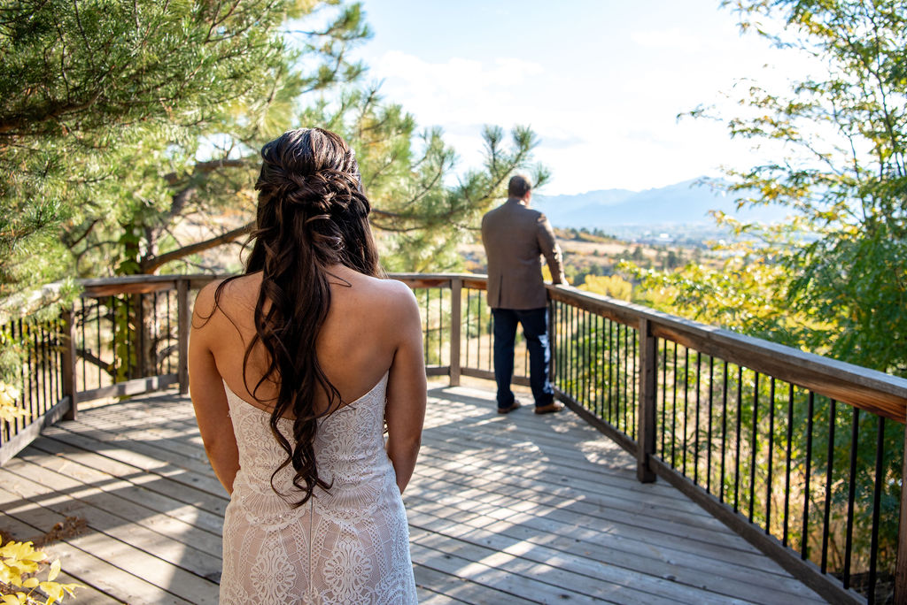Bride and groom stand on the balcony of their air bnb as they prepare for their "first look" in their wedding attire. 