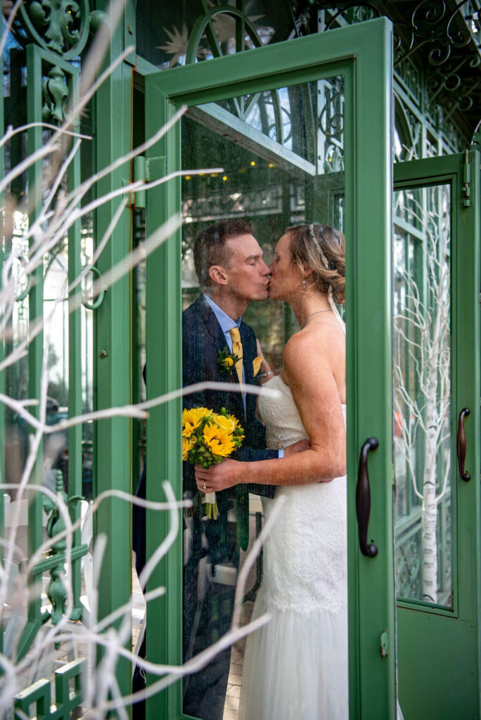 Couple kisses during their Denver Botanic Gardens Wedding