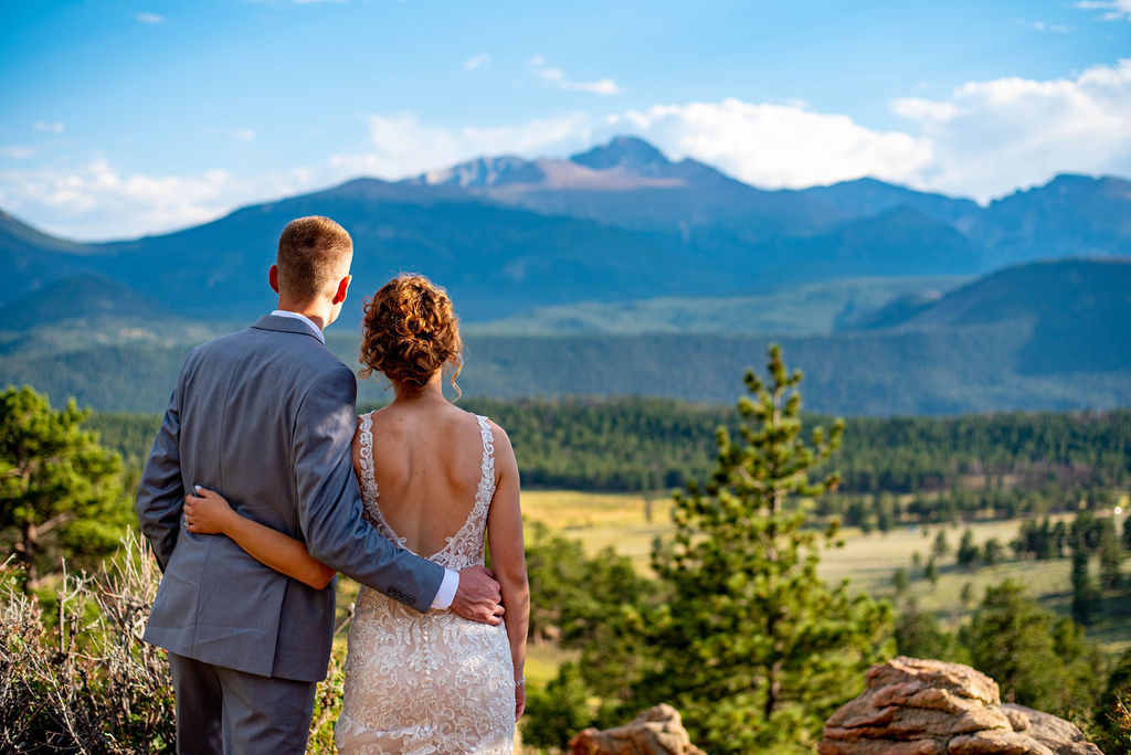 After their Estes Park elopement ceremony, bride and groom look out at the view. 