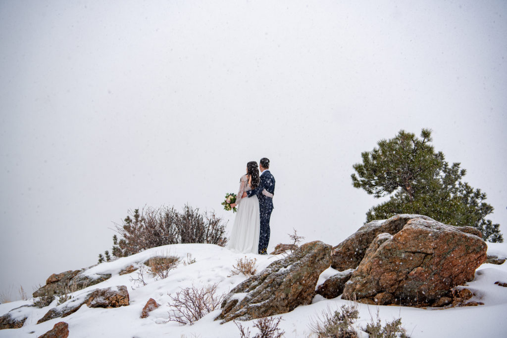 Colorado winter wedding couple enjoy the view after their ceremony
