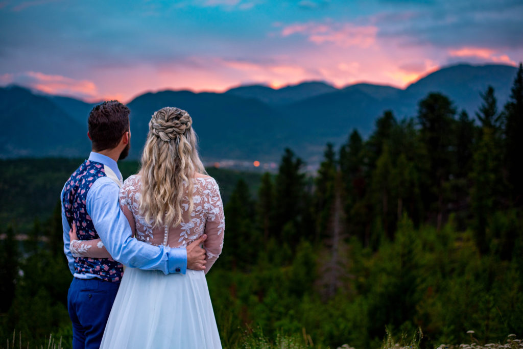 Bride and groom enjoy a sunset over the mountains the day of their Colorado mountain elopement 