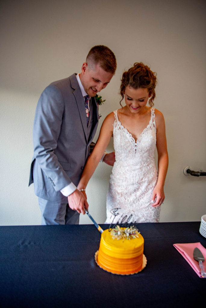 bride and groom cut their Estes Park elopement wedding cake. 