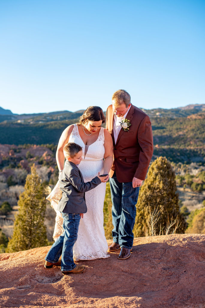 bride groom and their son include family in their elopement by having a video call.