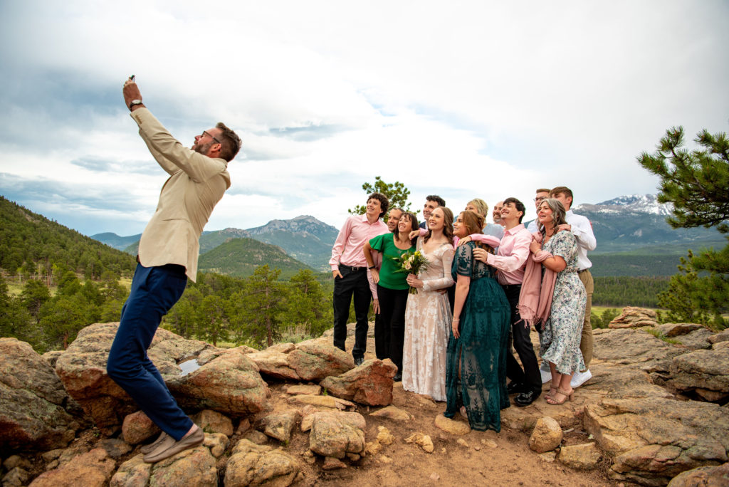 family member takes a selfie of all the guests at the mountain elopement 