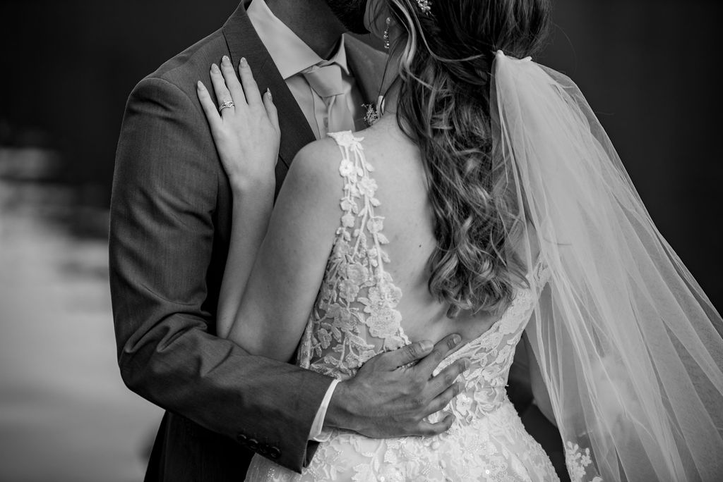 black and white close up photo of bride and groom hugging