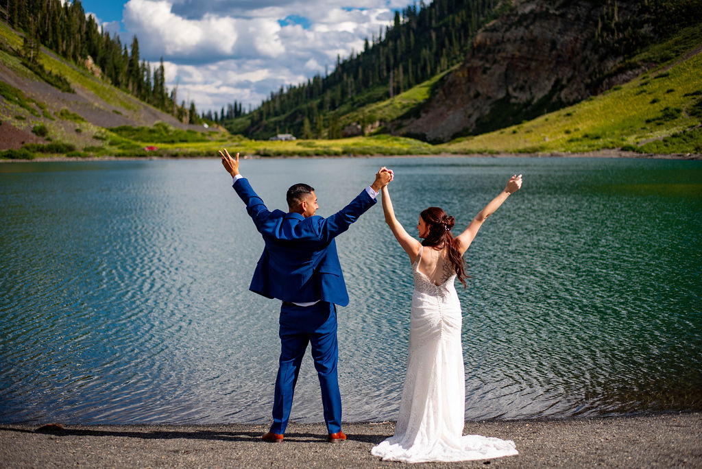 bride and groom with their hands in the air, excited about their crested butte elopement day