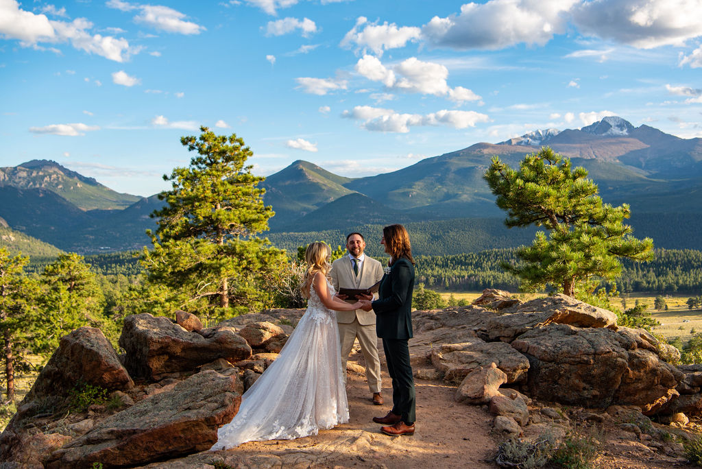 bride and groom holding hands during their elopement ceremony as they legally elope in colorado