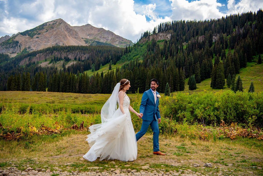 happy bride and groom with crested butte mountain backdrops