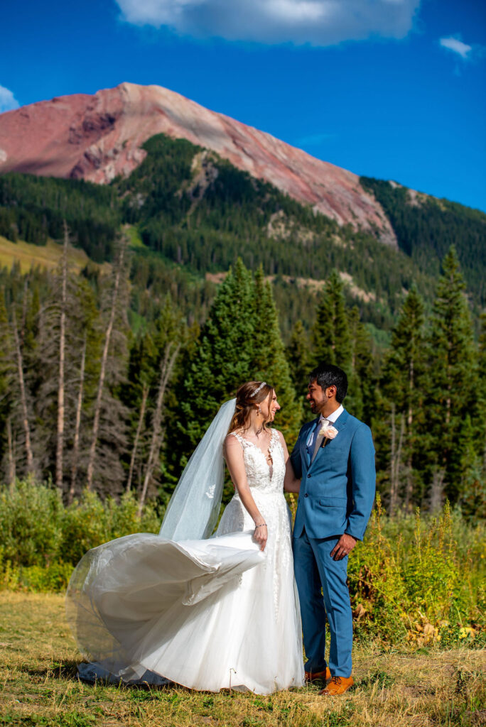 happy bride and groom with crested butte mountain backdrops