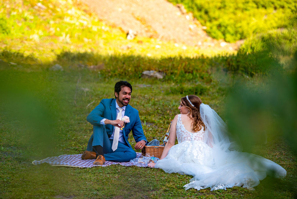 bride and groom enjoying their adventure elopement picnic