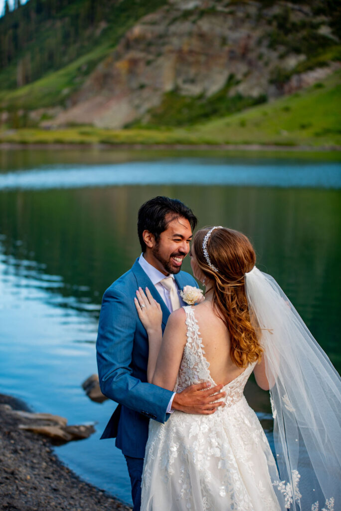 romantic bride and groom adventure elopement photo by an alpine lake