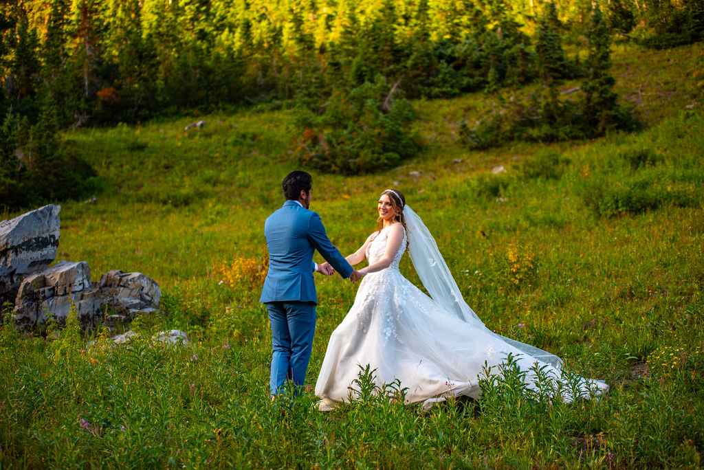 romantic bride and groom dancing in a wildflower field in crested butte