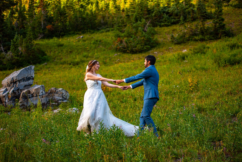 romantic bride and groom dancing in a wildflower field in crested butte
