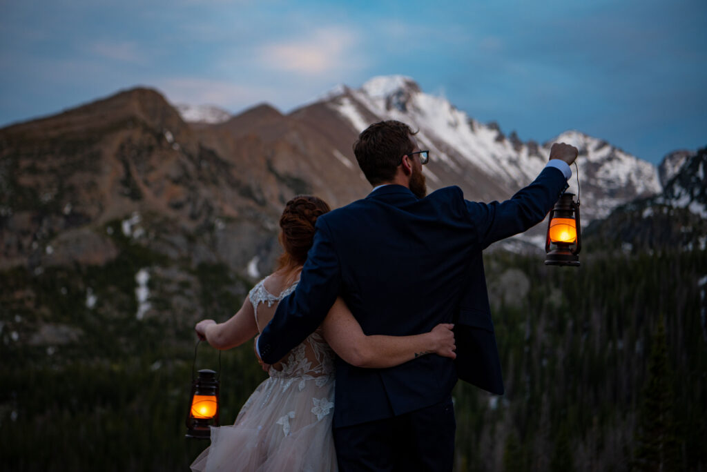bride and groom holding lanterns for an evening photo