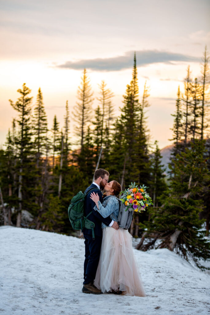 adventurous bride and groom hiking together during their Colorado winter wedding elopement