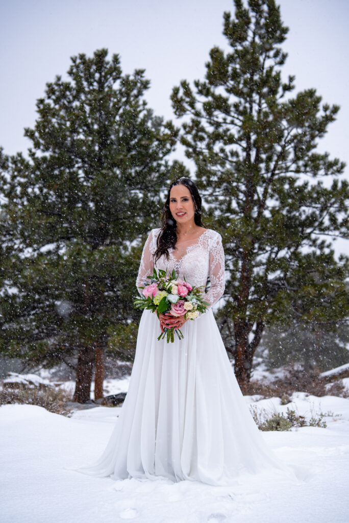 bride portrait while snow is slowly falling