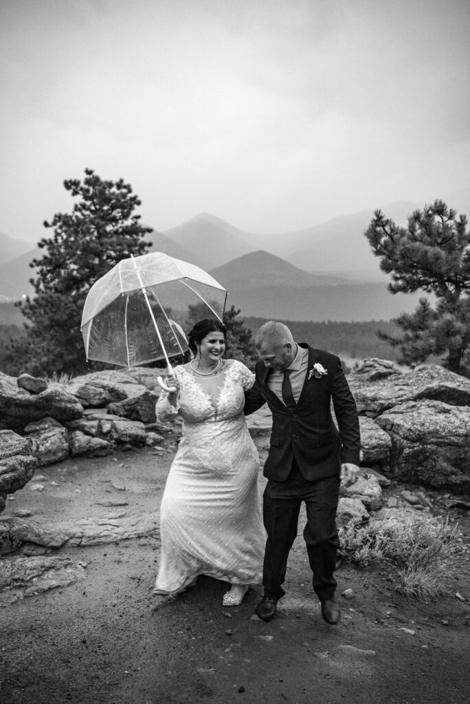 bride and groom with a clear umbrella during their rainy colorado elopement