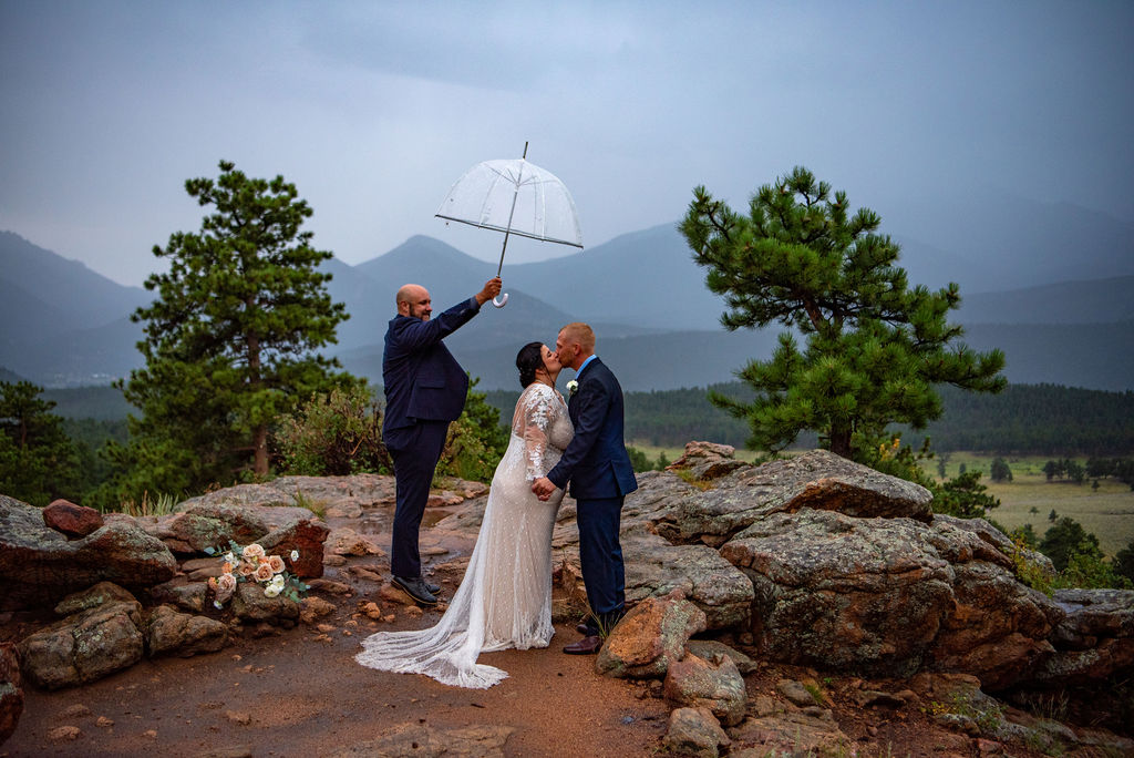 bride and groom with a clear umbrella during their rainy colorado elopement