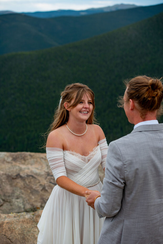 bride and groom exchanging vows during their mountain elopement ceremony in Colorado