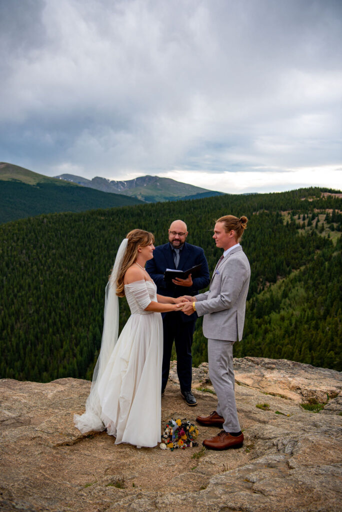 bride and groom exchanging vows during their mountain elopement ceremony in Colorado