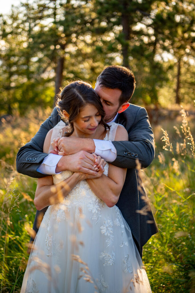 bride and groom in a lush field
