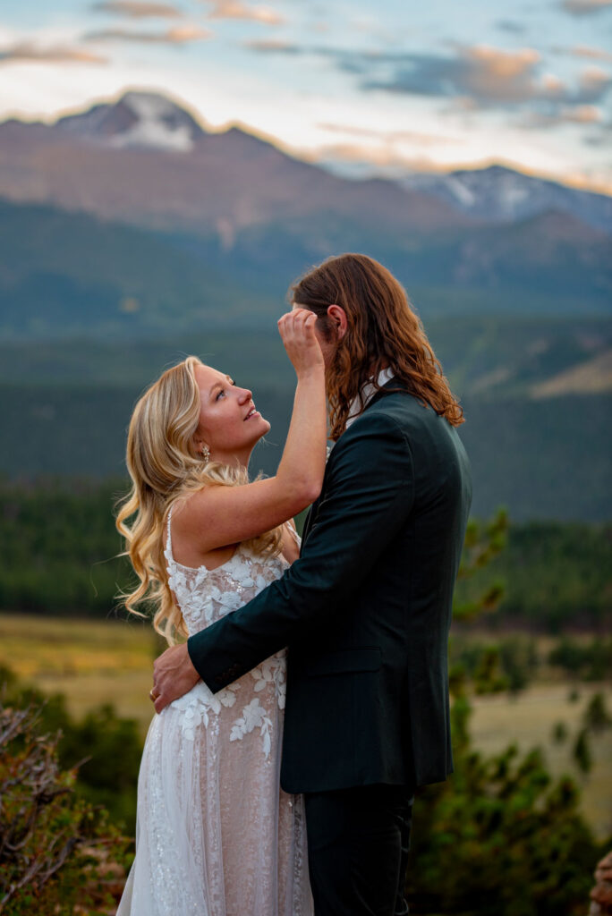 playful bride and groom photos during their elopement in colorado with mountains in the backdrop