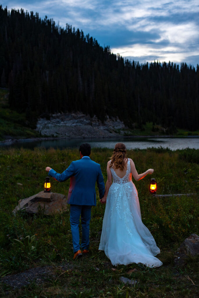 bride and groom posing with lanterns during their nighttime elopement photos