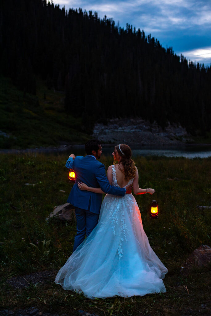 bride and groom posing with lanterns during their nighttime elopement photos