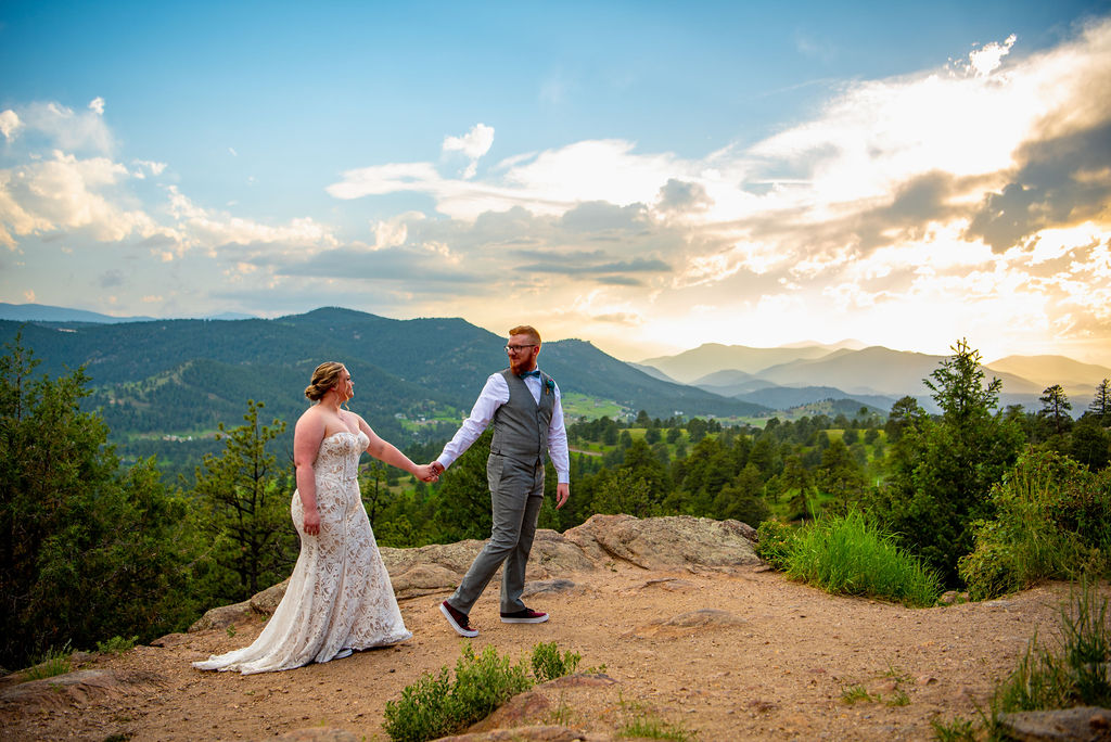 playful bride and groom photos during their fort collins elopement in colorado with mountains in the backdrop