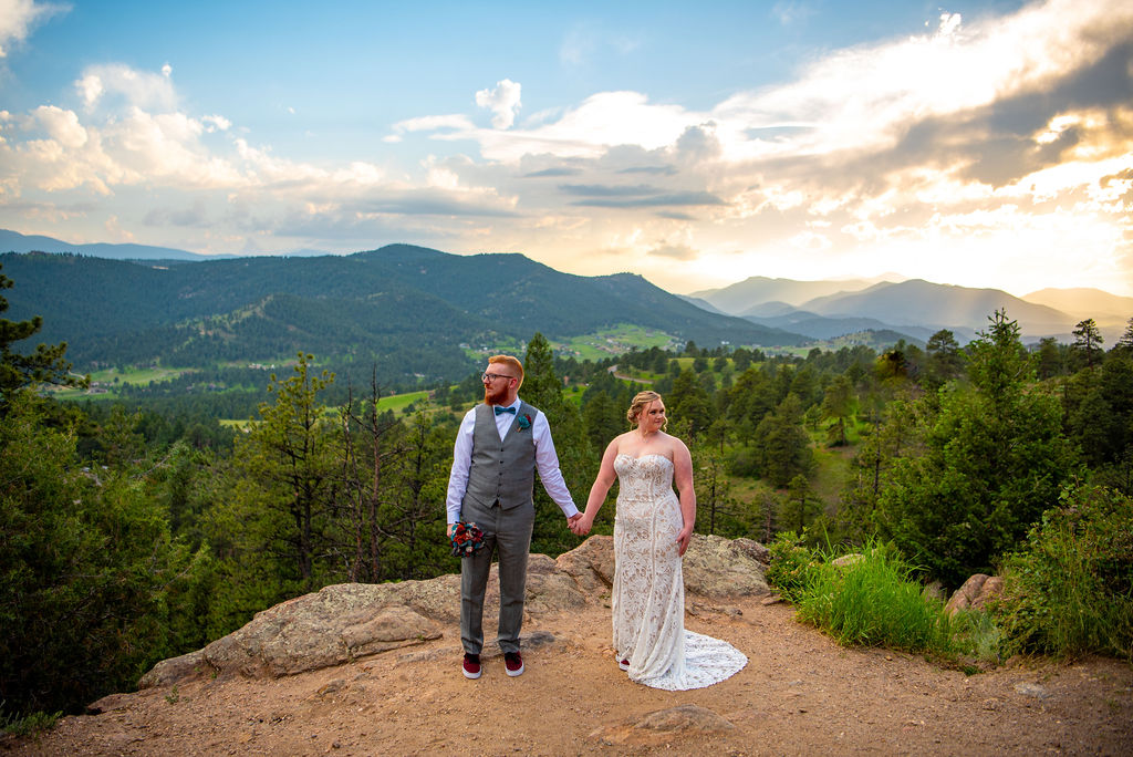 playful bride and groom photos during their fort collins elopement in colorado with mountains in the backdrop