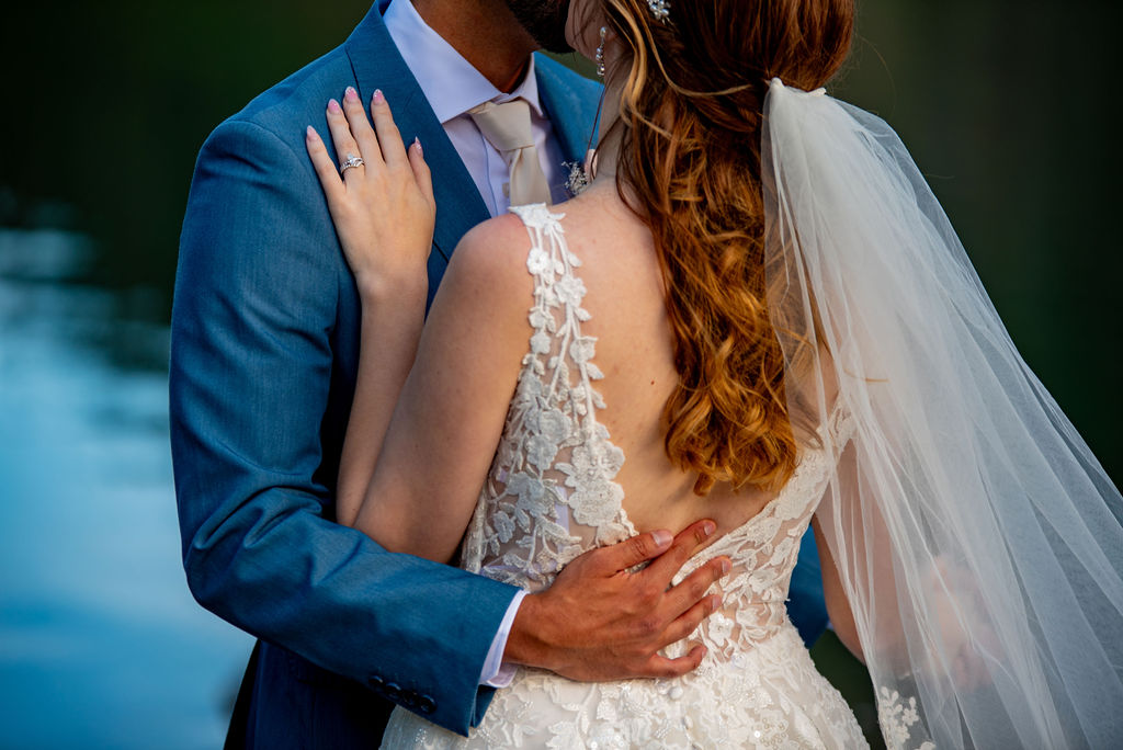 close up of a bride and groom hugging