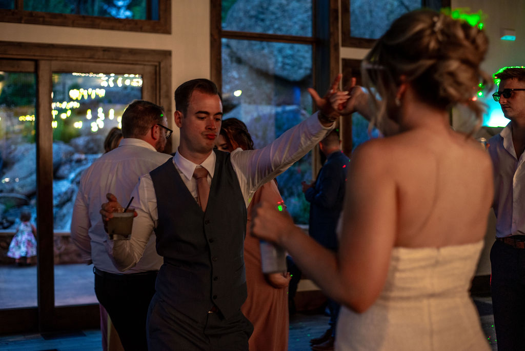 fun wedding couple at the reception