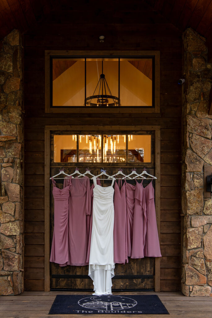 bride and bridesmaid dresses hanging outside the wedding venue