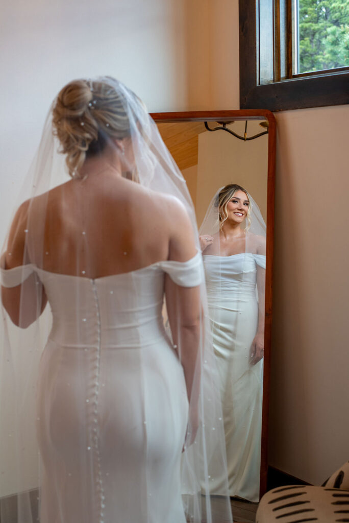 bride getting ready by the mirror