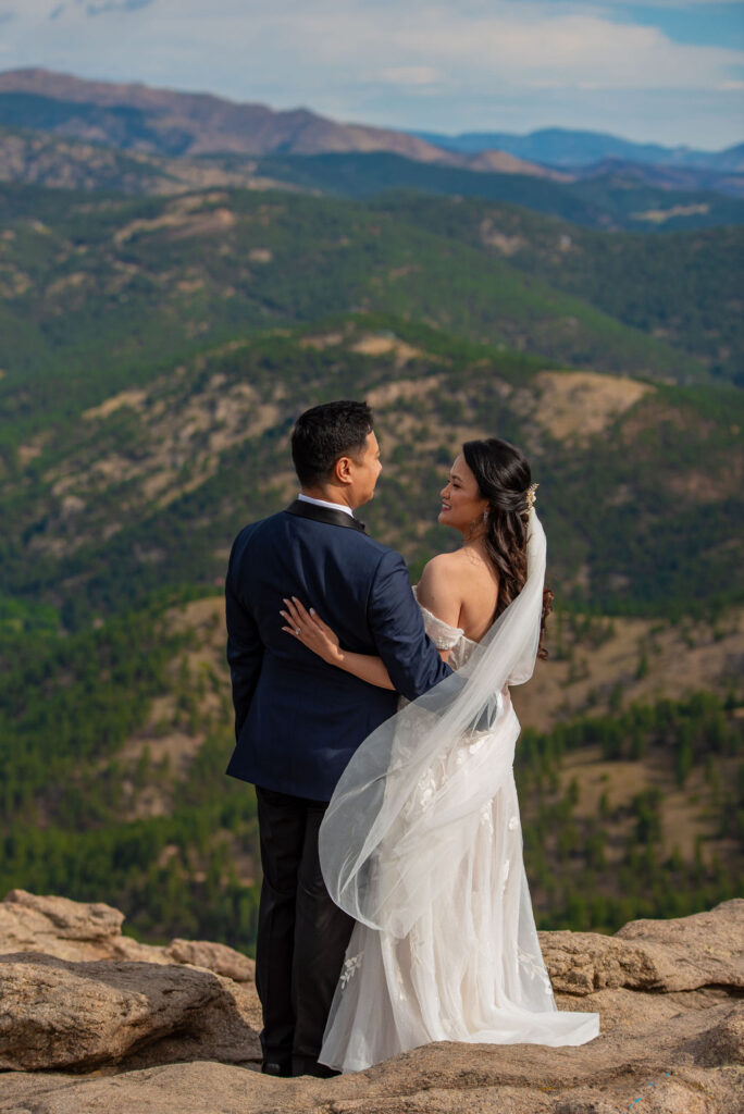 Bride and groom admire sweeping mountain views after their Boulder Halfway House wedding, capturing a quiet moment at Lost Gulch Overlook.